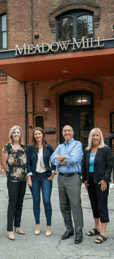 The Jenner la Firm Team standing outside the Meadow Mill building in Baltimore